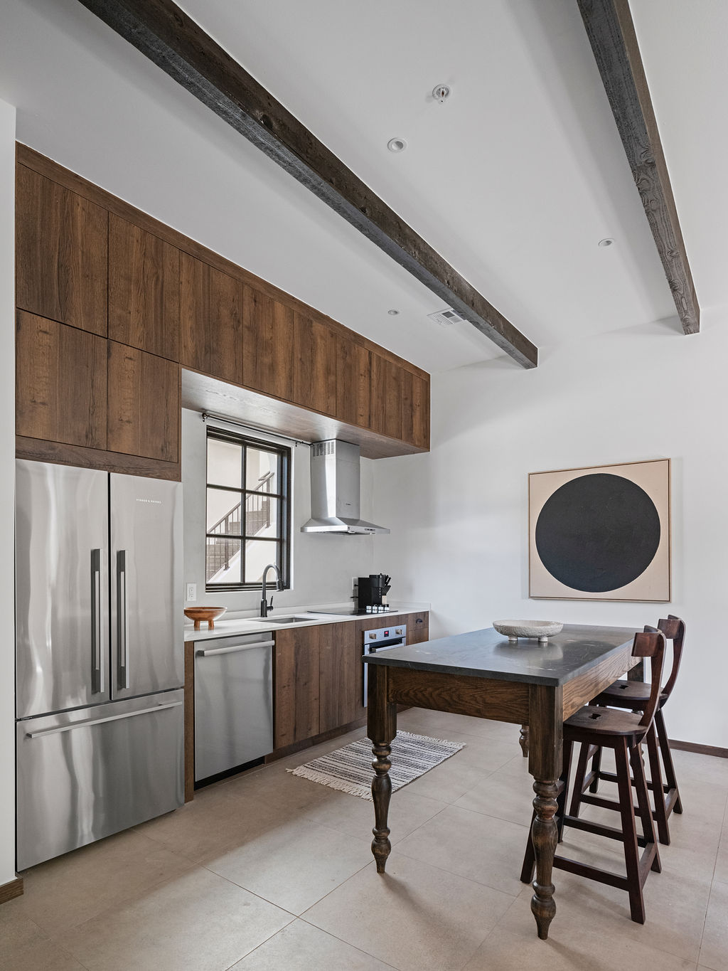 a kitchen with a refrigerator, stove, sink and microwave